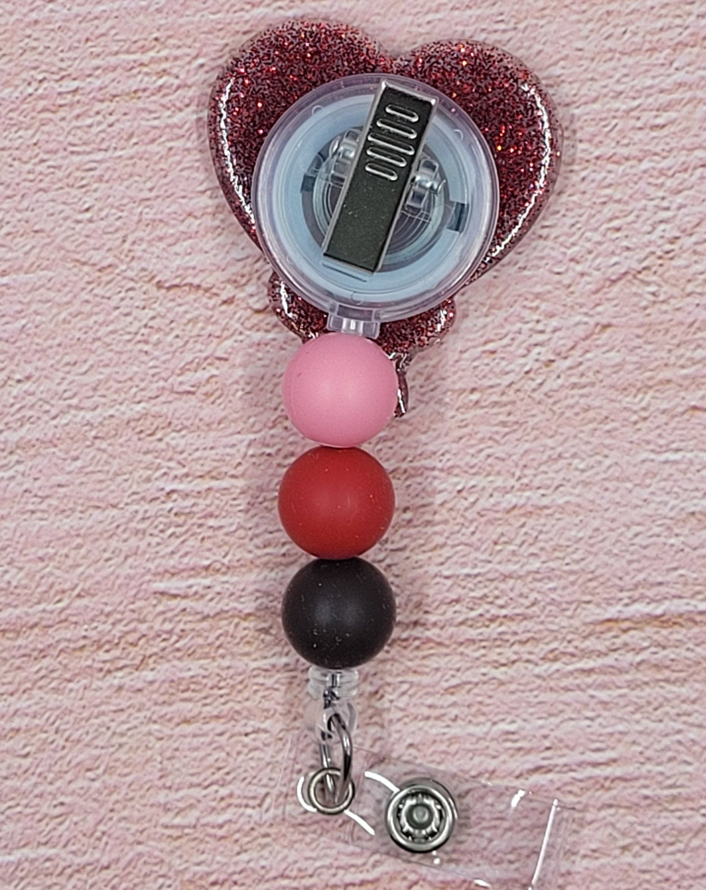 Chocolate covered strawberries....out....Chocolate covered heart.....in with sprinkles! New to our badge reel line this one will surely steal someone's heart. Featuring a red glitter base and coordinated beads, this is the perfect accessory for the holiday season.