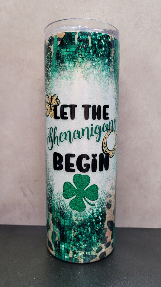 Let The Shenanigans Begin! This 20 oz tumbler features that phrase over a cheetah print background with splashes of Irish greens and luck charms.