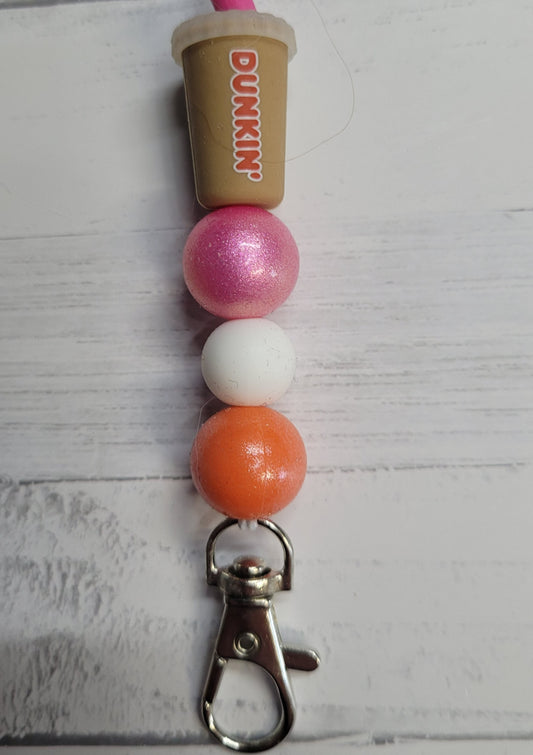 Need a custom Freshie Hanger? Here is a silicone beaded hanger we like to call Dunky. Has an iced coffee drink container as a focal bead with corresponding colored beads to finish the look. Attaches quickly to any one of our many Freshies so you can easily hang it from your rear view mirror.