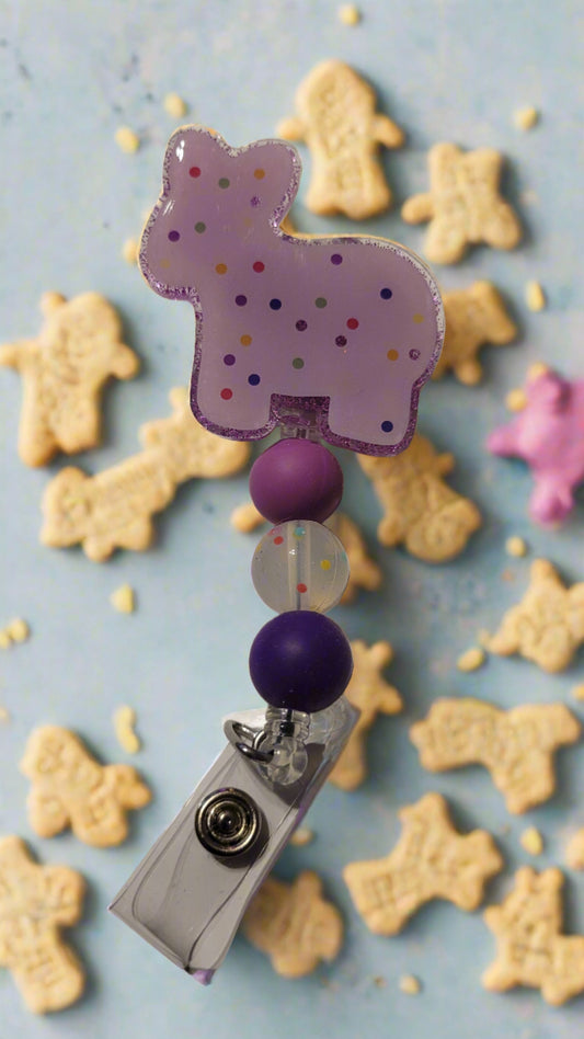 Frosted animal crackers with sprinkles are brought to life in these delicious Badge Reels! Our first offering is the stubborn yet adorable donkey - pick from a variety of colors and complementing silicone accent beads.