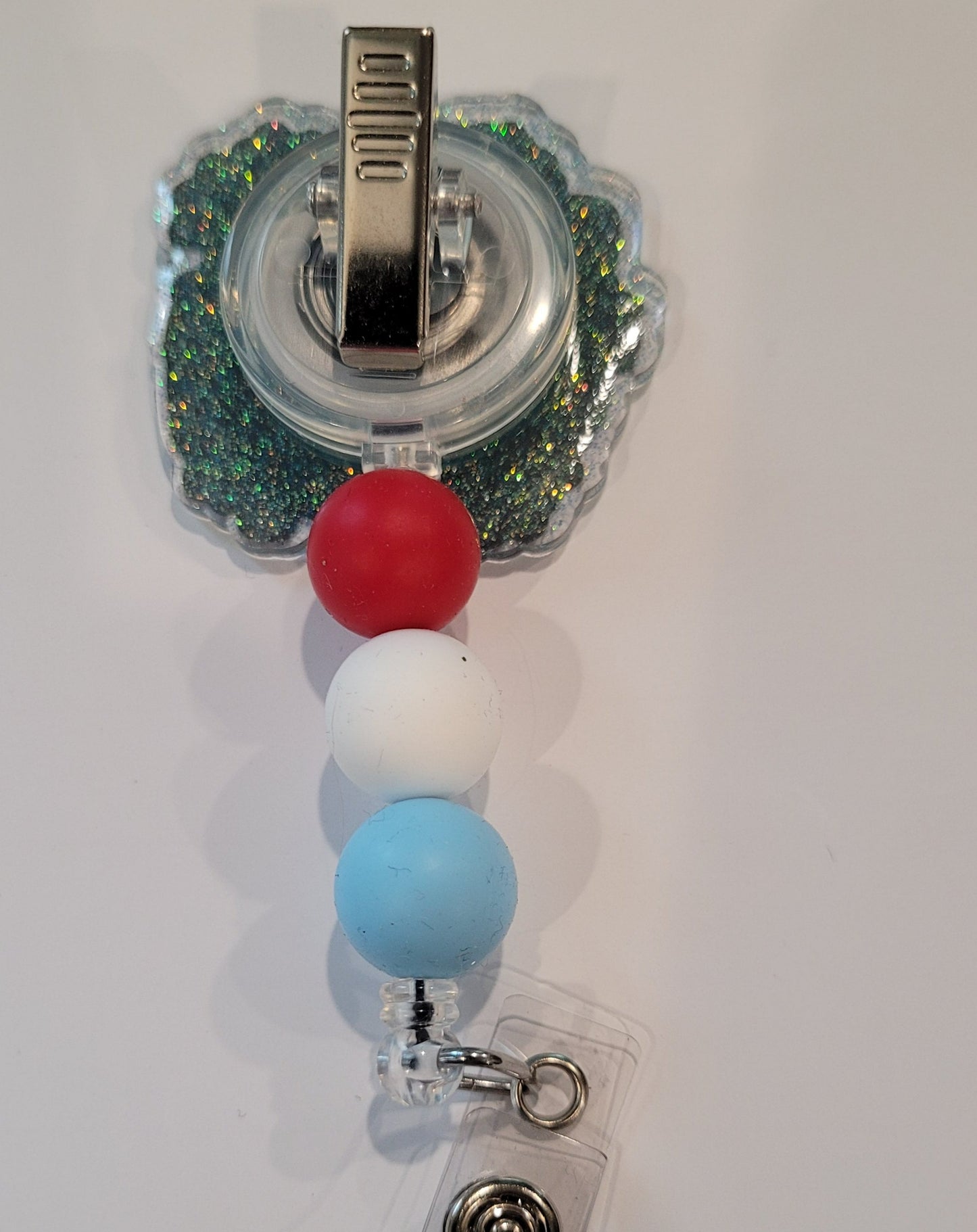Experience the best 4th of July vibe with this Red White &amp; Bluey Badge reel. Adding a touch of patriotism, this badge reel flaunts red, white, and blue silicone accent beads, perfect for watching the fireworks on our Nations Birthday..