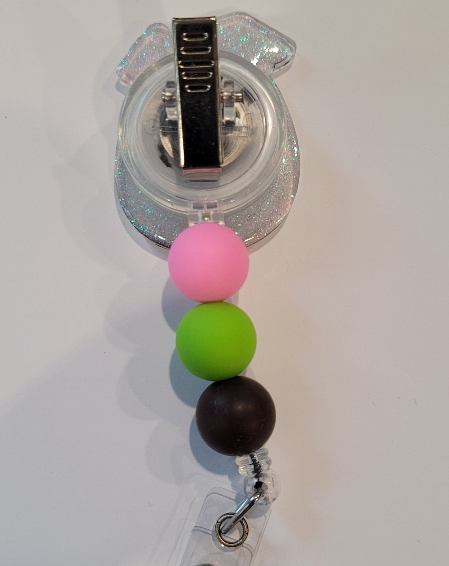 Enjoy this tasty Caribbean Cocktail Badge Reel that any rum lover would be happy to have. Sporting a drink in a coconut shell with umbrella &amp; straw, glitter back and 3 color coordinated silicone beads to finish the look. Last Call!&nbsp;