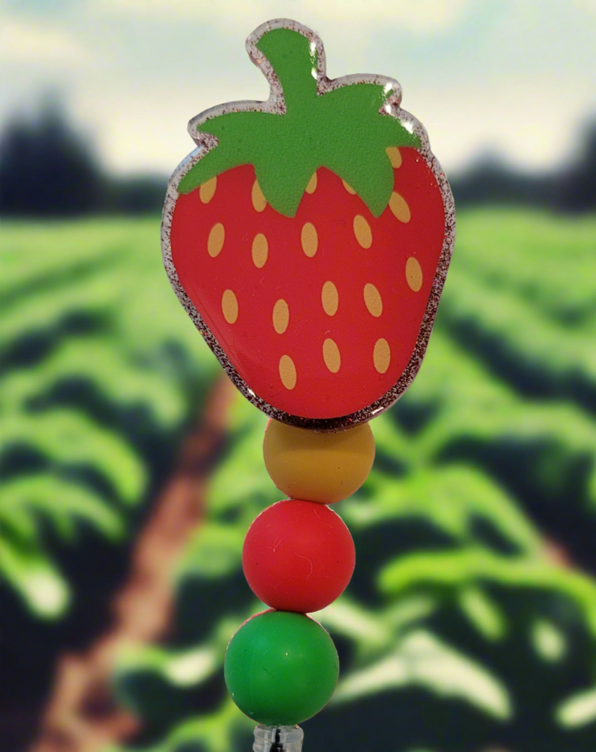 Experience the summer season with this strawberry acrylic badge reel. A red glitter back and highlighting silicone accent beads finish this tasty look.