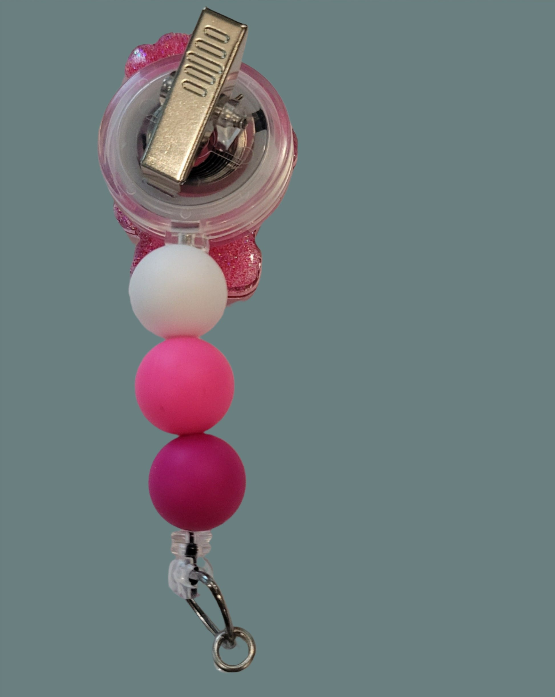 Looking for a charming badge reel? Well, look no further because we've got our Secret&nbsp; Bear here! With a glittery pink back and 3 matching silicone beads, it's perfect for all the bear lovers out there. This is 1 of 5 variations.