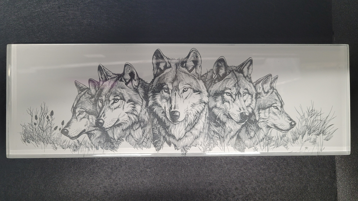 This basic glass wall tile as been transformed into a beautiful laser engraved wolf collage image. The fine detail from the laser really shines through on the white background. Measuring 4" tall x 12" wide and 1/4" thick, this tile is a strong sturdy piece. Black felt backing allows you to display flat on a table or use the white washed wooden easel that comes with it. You could even use in a remodel and put in a tiled wall if you so choose or display it for yourself or a gift for family or friend,