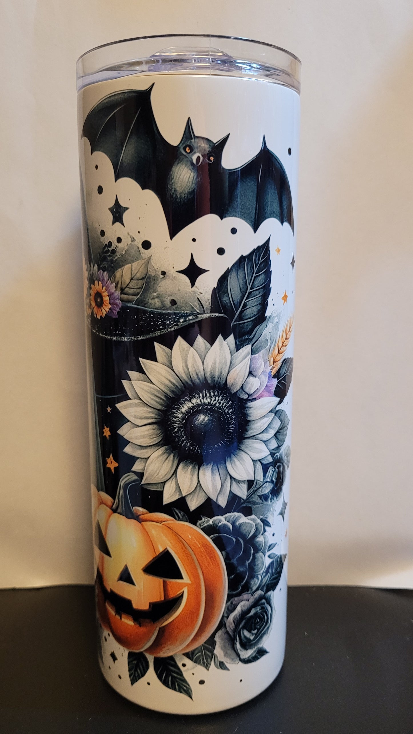 &nbsp;Not all ghosts are scary. Take this adorable Sunflower Ghost wearing a witch hat with a bat overhead and a carved pumpkin in the foreground. This is a stainless tumbler that mirrors our glass can tumbler version.  This 20 oz Tumbler from Makerflo is double walled from stainless with great insulating properties.