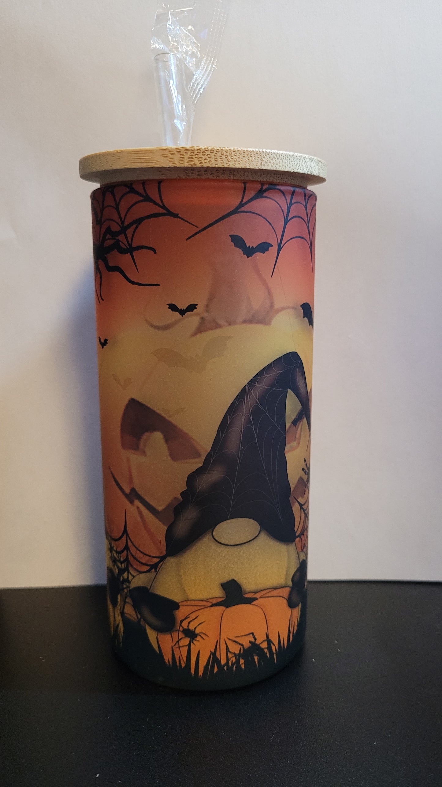 Conquer the pumpkin patch with 3 fearless gnomes and a formidable giant jack o lantern lurking behind them! This dynamic scene is sublimated onto a sturdy glass tumbler, complete with a straw and a bamboo lid. Defy the odds and embrace the thrill with every sip.