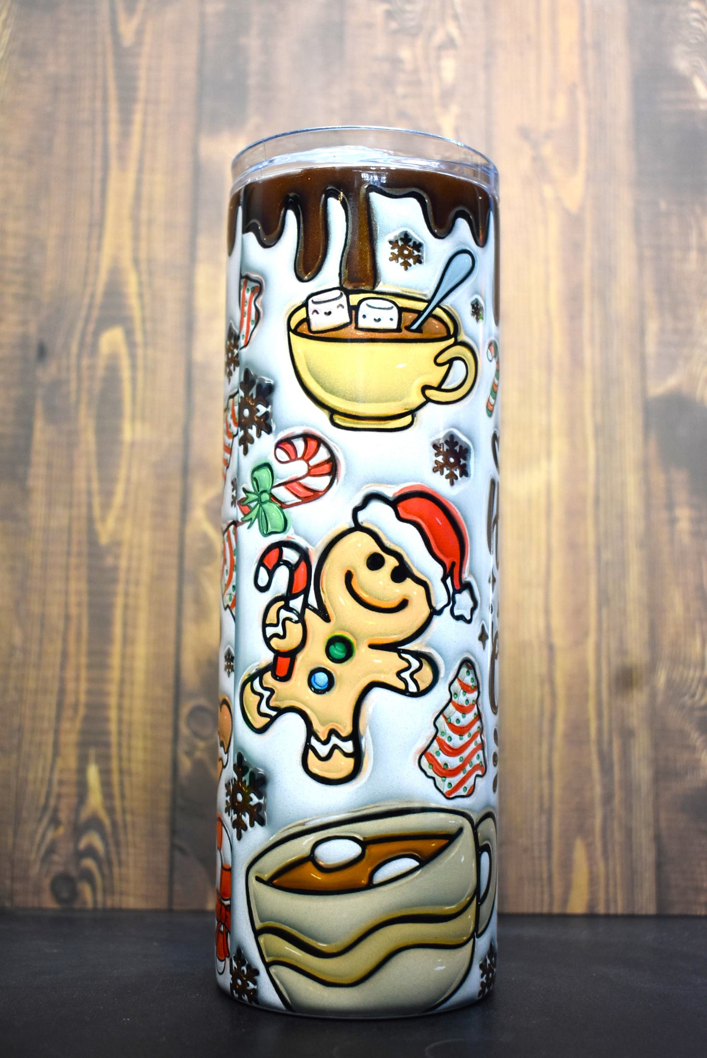 The ultimate Christmas Season tumbler here with the phrase " I Just Want To Drink Hot Cocoa And Watch Christmas Movies. A unique 3-D printed design featuring cups of hot cocoa, gingerbread cookies and various classic Christmas time snacks.