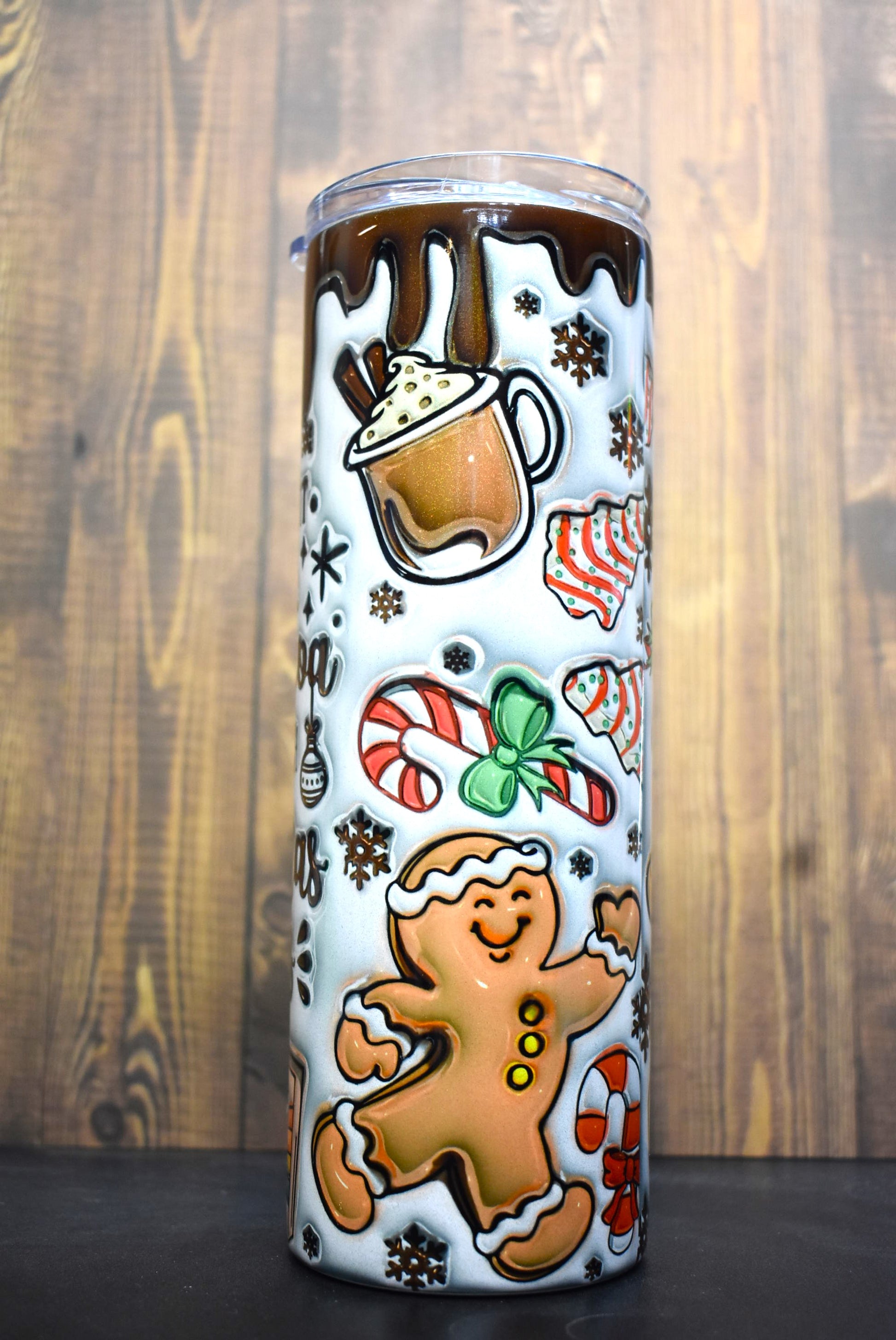 The ultimate Christmas Season tumbler here with the phrase " I Just Want To Drink Hot Cocoa And Watch Christmas Movies. A unique 3-D printed design featuring cups of hot cocoa, gingerbread cookies and various classic Christmas time snacks.