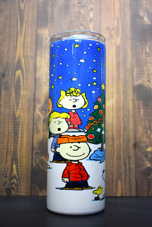 It's a Peanuts Christmas. The whole gang from Charlie Brown, Snoopy, Woodstock and more stand outside under the stars singing Christmas carols by the tree, 