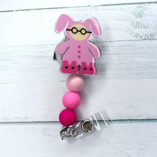 Our classic acrylic badge reel features Ralphie from the classic Christmas Story movie in his iconic pink bunny suit, accompanied by three shades of matching silicone beads.