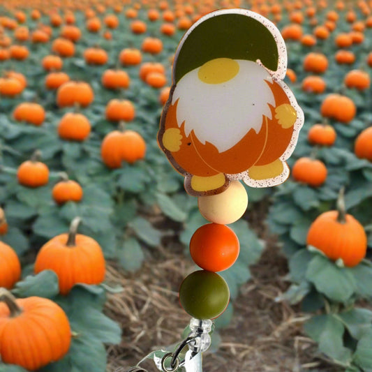 Harvest season brings this adorable acrylic Gnome Pumpkin badge reel with tan, orange, and green silicone accents.