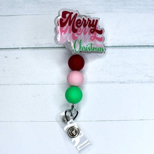 This acrylic badge reel features festive red, pink and green silicone beads, perfect for wishing everyone a Merry Christmas.