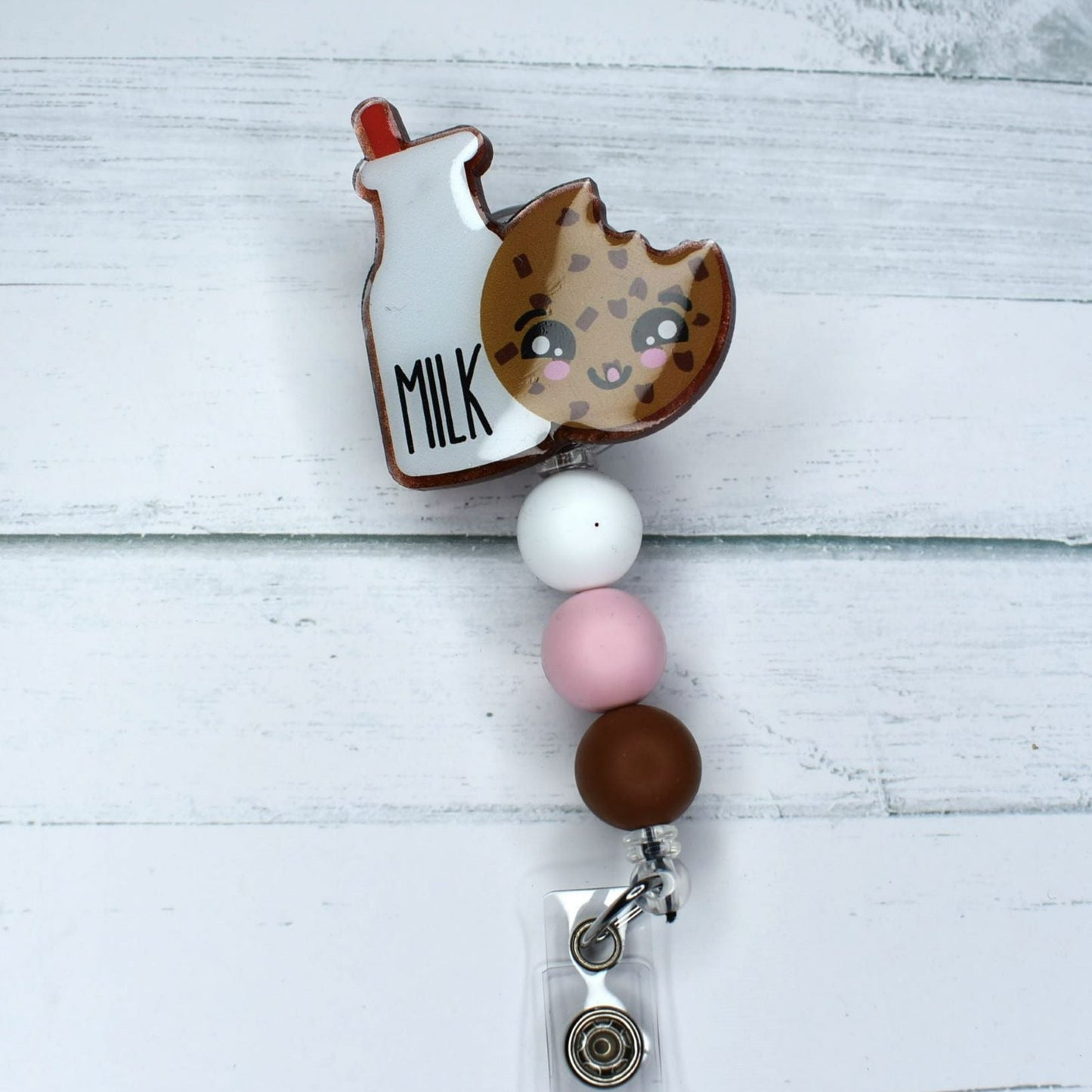 The classic combination of Milk & Cookies is featured prominently on this acrylic badge reel, finished with white, pink, and brown silicone bead