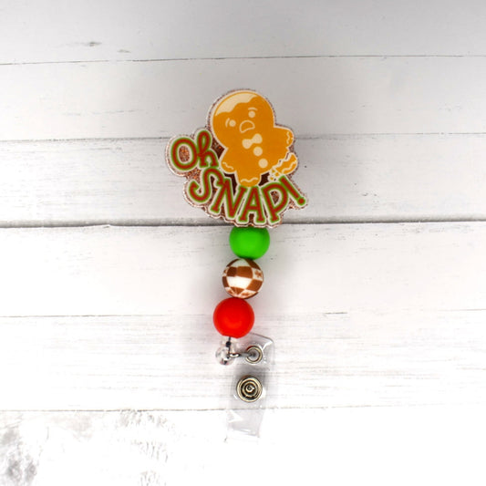 Oh Snap....2 words NO Gingerbread Man EVER wants to hear. Featuring a glitter base with a gingerbread focal bead and 2 other color coordinating silicone beads, this badge reel is sure to make anybody smile.
