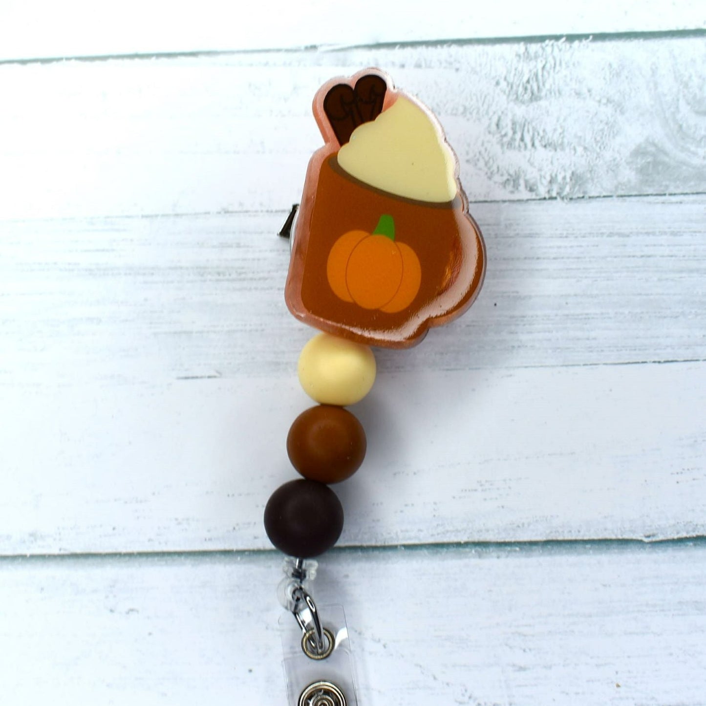 Nothing quite says fall like an iconic Pumpkin Latte - and these acrylic badge reels look just as delicious. Available in two different color schemes on the silicone accent beads.