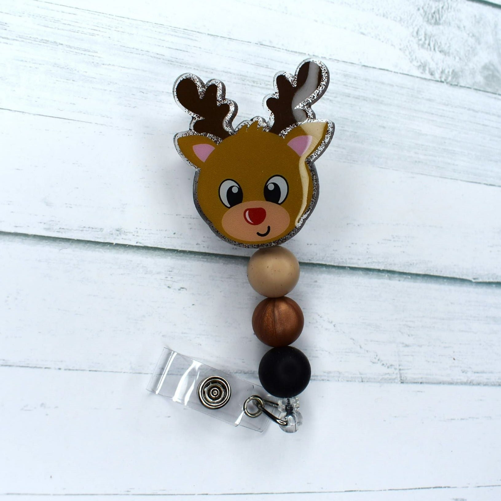 This acrylic Reindeer badge reel is the perfect way to show off your holiday spirit, featuring tan brown & black silicone accents. Get into the Christmas spirit--you can almost hear the sound of sleigh bells!
