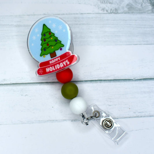 Make your Holidays extra special with this acrylic badge reel featuring a festive Christmas Tree inside a snow globe, complete with red, white, and green silicone beads.