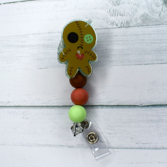 Feel like a pin cushion? Here is our Voo Doo Doll acrylic badge reel. Sure to be what the Witch Doctor called for! Brown green & dark salmon silicone beads finish the hex.