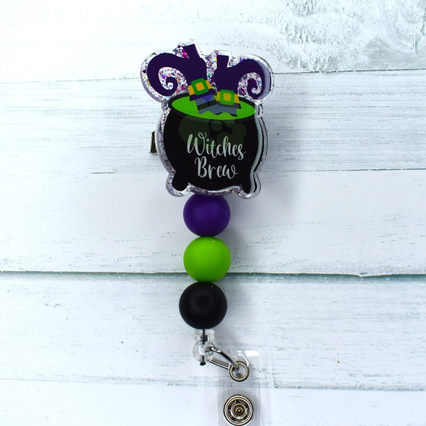 Hopefully one of the Sanderson sisters didn't fall in their kettle on this acrylic badge reel, complete with matching colored beads, to create a powerful Witches Brew.  Witches brew or witches stew?