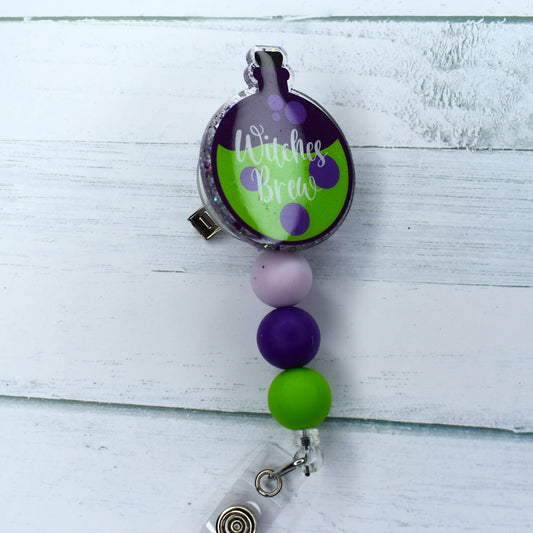 The Sanderson sisters have crafted this acrylic badge reel, complete with matching beads, to create a powerful Witches Brew Potion.