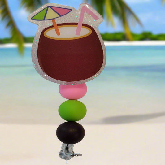 Enjoy this tasty Caribbean Cocktail Badge Reel that any rum lover would be happy to have. Sporting a drink in a coconut shell with umbrella &amp; straw, glitter back and 3 color coordinated silicone beads to finish the look. Last Call!&nbsp;