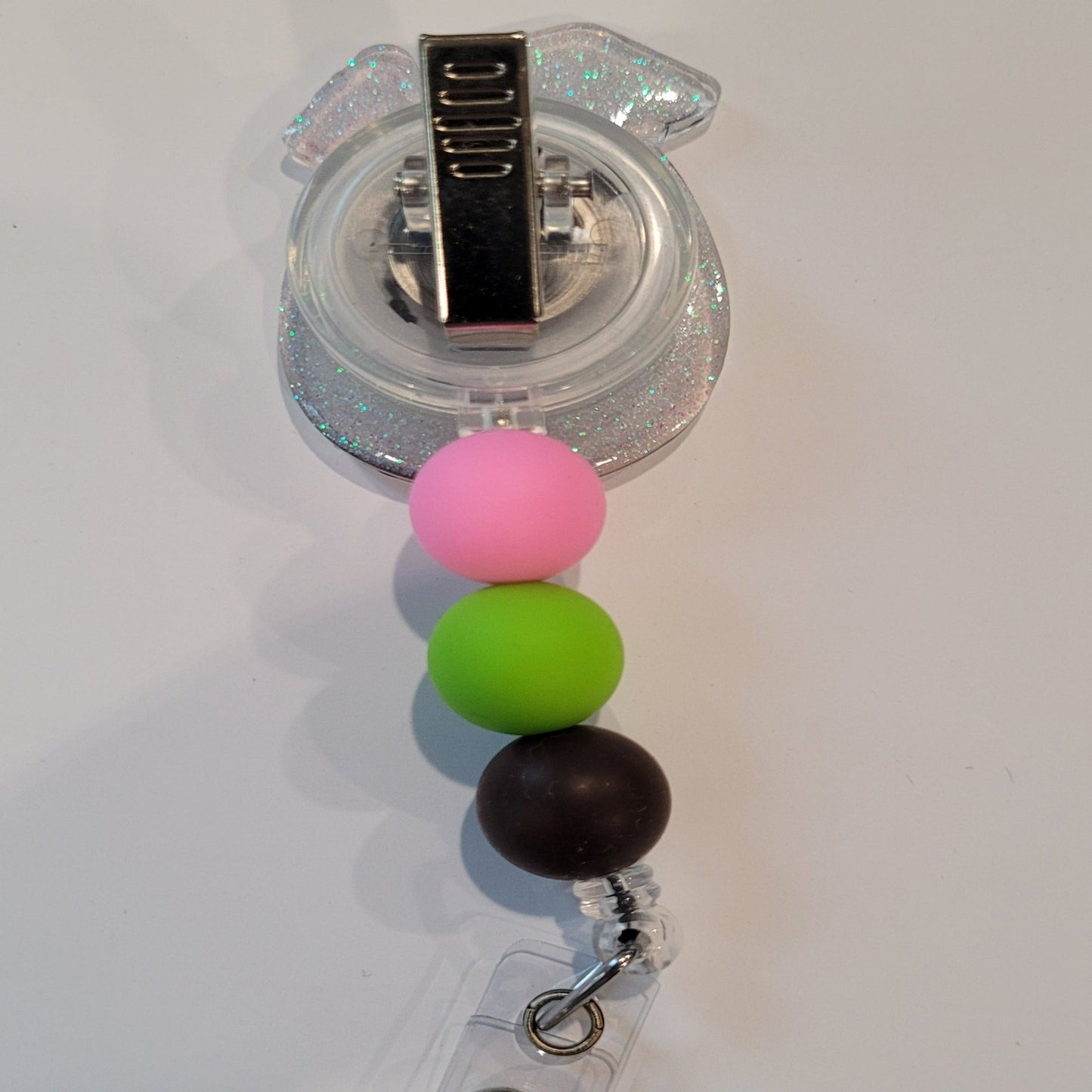 Enjoy this tasty Caribbean Cocktail Badge Reel that any rum lover would be happy to have. Sporting a drink in a coconut shell with umbrella &amp; straw, glitter back and 3 color coordinated silicone beads to finish the look. Last Call!&nbsp;