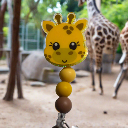 Fun Fact.... Giraffes are the tallest animals on our planet, and this cute Giraffe badge reel will never come up short and making people smile when they see it. With a green glitter background and 3 color coordinated matching silicone beads this one is sure to please.