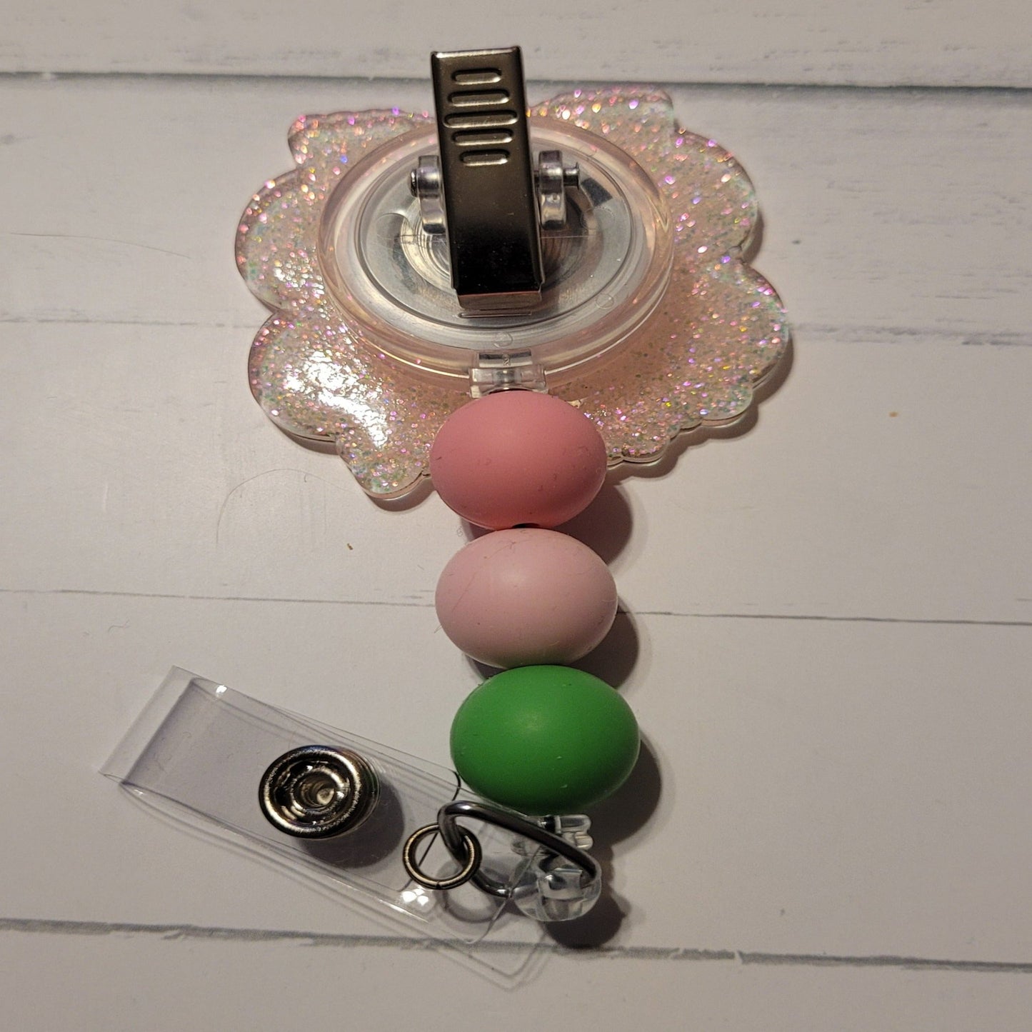 Unleash your inner whimsy with this delightful Badge Reel starring a charming little Fairy Piggy, complete with flower-festooned wings and a sparkling pink backdrop. And don't forget the adorable trio of matching silicone beads for a dash of extra charm. Perfect for all animal enthusiasts!