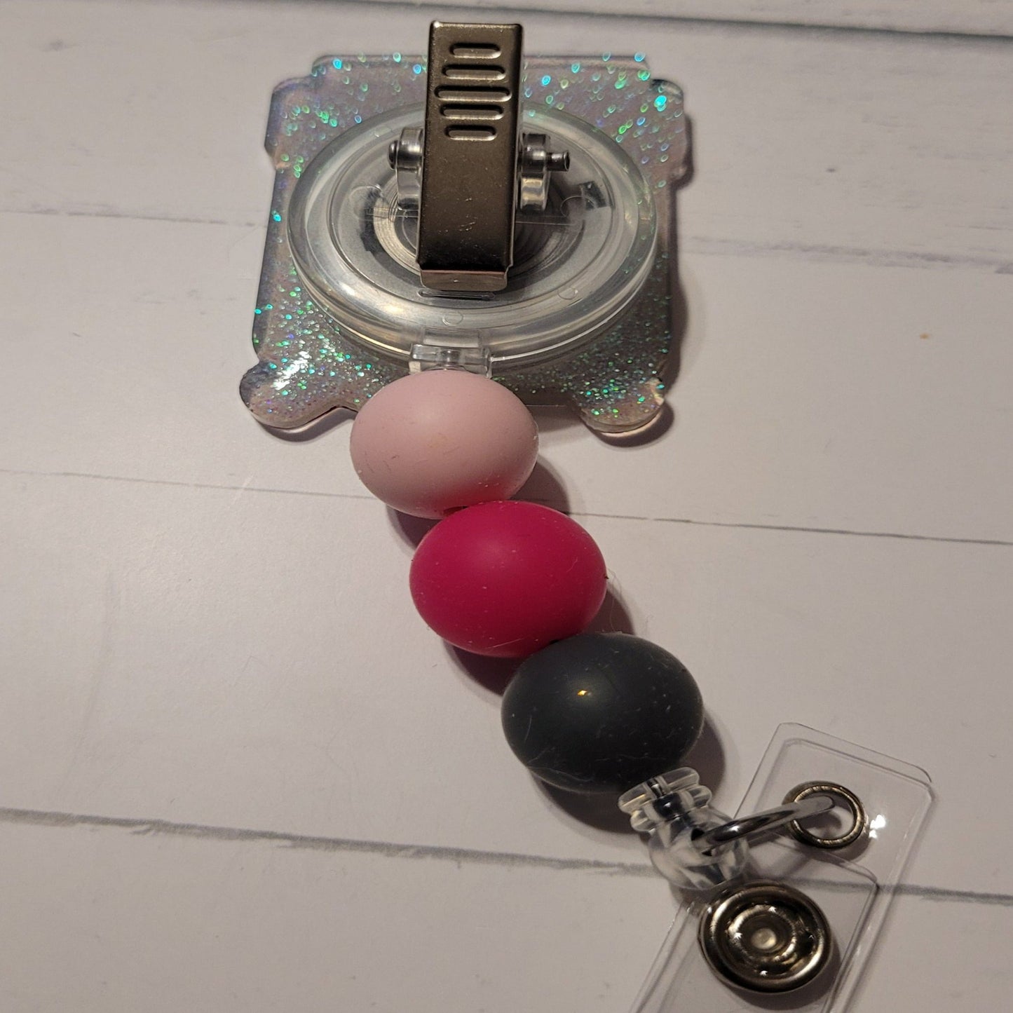 Part of our latest collection of Medical Badge Reels available now, we can write you a script for this Happy Pill Badge Reel. Featuring a happy face and a light blue glitter base adorned with coordinating beads, this Badge Reel is sure to catch the eye.