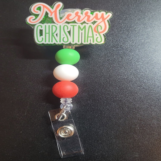 Straight to the point with this badge reel. Merry Christmas. A green glitter back and 3 silicone matching beads add to the look. An excellent choice for a stocking stuffer.