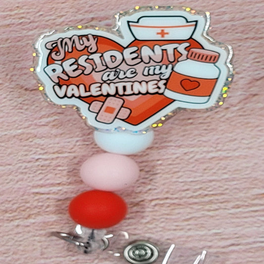 For all those in the medical field that what to show their residents who their Valentine is... we give you the My Residents Are My Valentines Badge Reel. This heart shape badge reel with band aids, pill bottle and a retro nurses hat on a clear glitter base is a definite eye catcher. 3 color coordinated silicone beads finish the look.