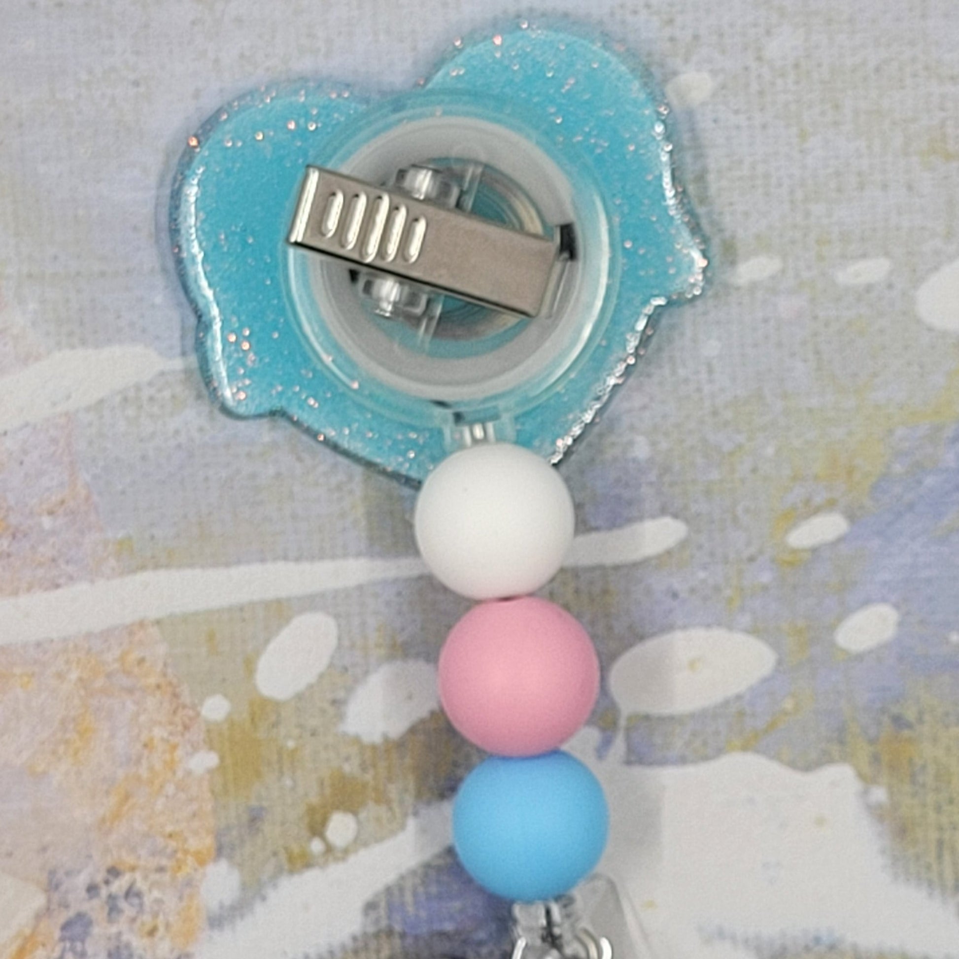 Introducing the new Nurse Badge Reel, part of our latest collection of Medical Badge Reels available now. Featuring Nurse in Blue lettering over a pink heart and a light blue glitter base adorned with coordinating beads, this Badge Reel is sure to catch the eye.