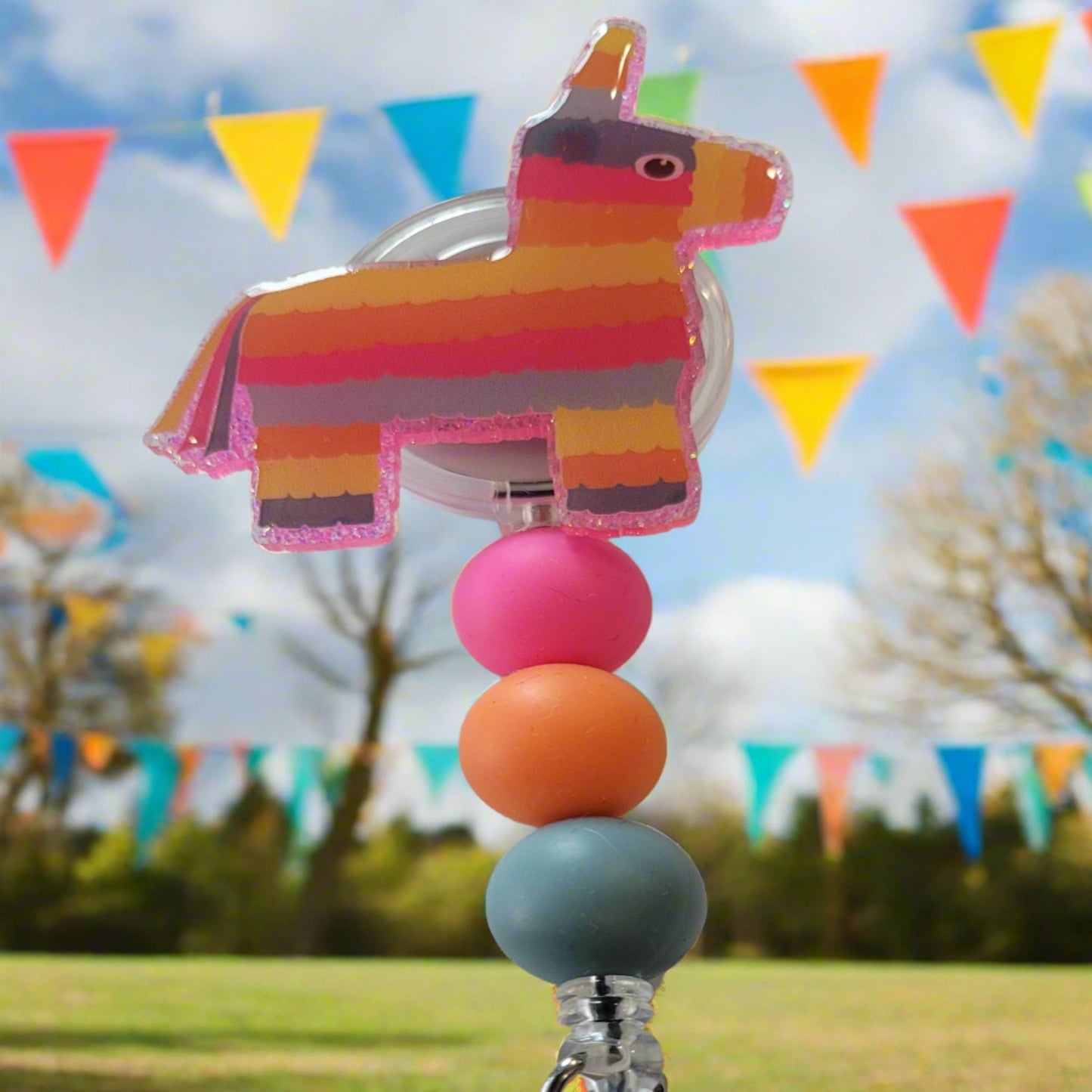 Summer means party time and Pinatas! This adorable Party Pinata Donkey has colorful stripes on the front, a glittery pink back, and silicone beads that match the colors.