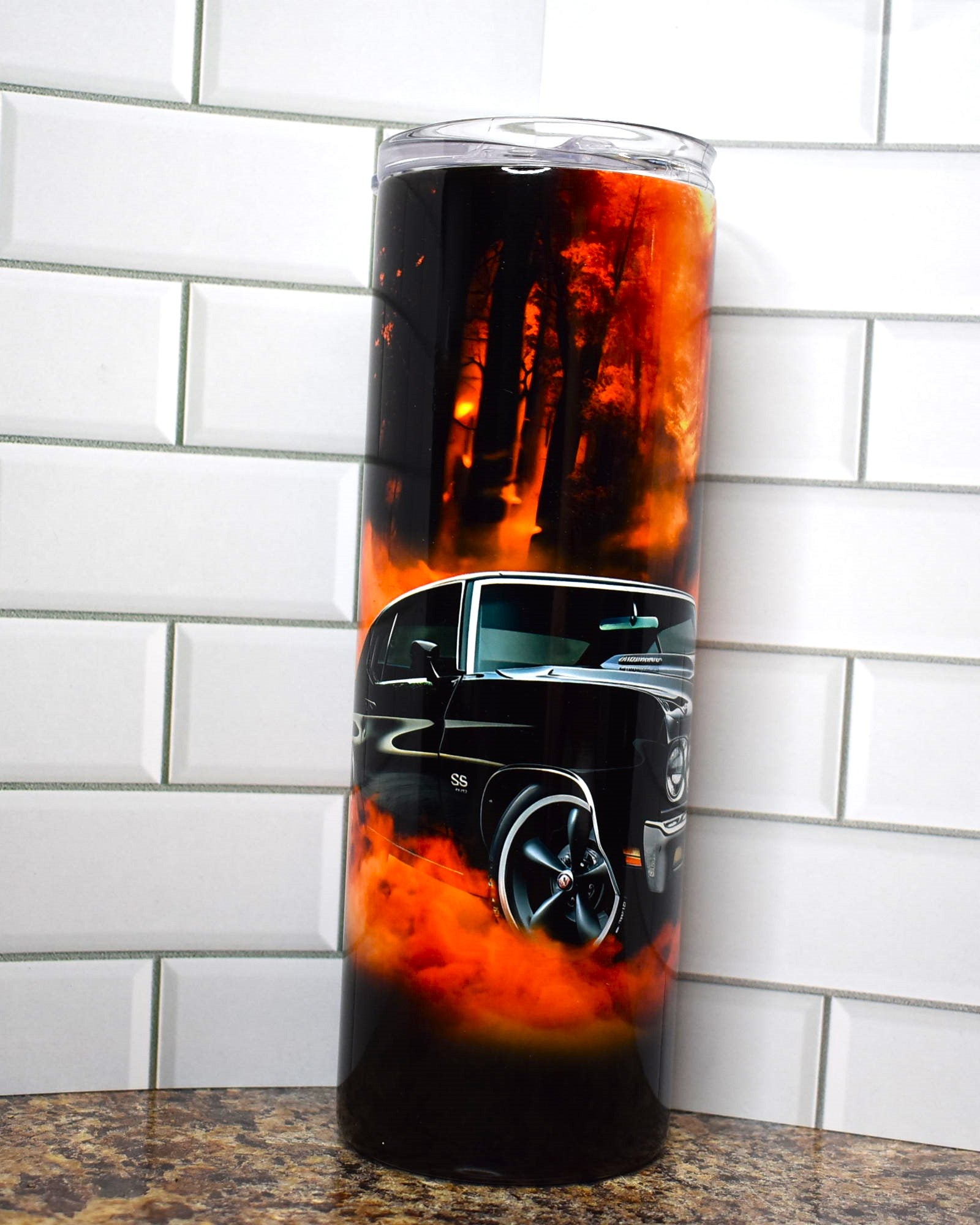 Muscle cars ruled the roads and this tumbler pays homage to the Chevelle SS in classic black with flames under the chassis and a woodlands background.