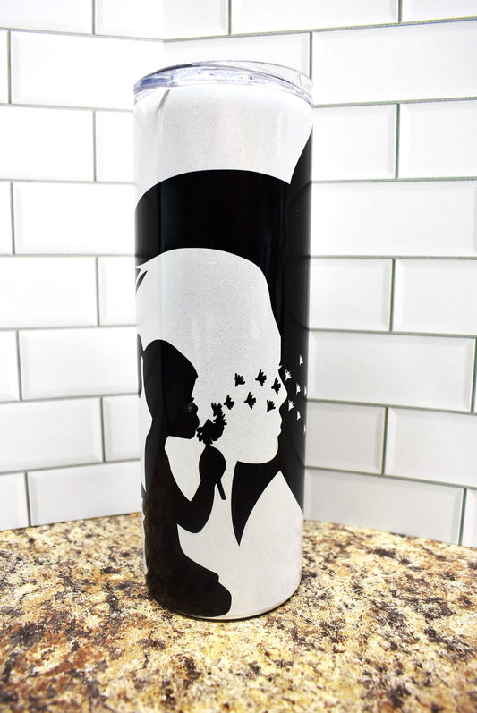 20 oz Stainless Steel tumbler. Simple but meaningful. Black silhouette of a horse, woman, child and dandelions on a glitter holographic tumbler.
