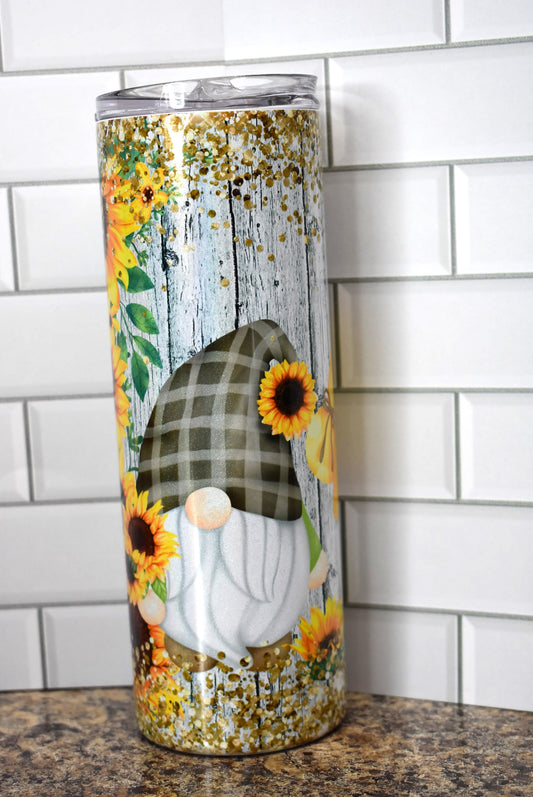 20 oz Makerflo Stainless Steel Tumbler With Gnomes Enjoying Sunflowers with chunky gold glitter flakes top & bottom. We put this image on our holographic glitter series
