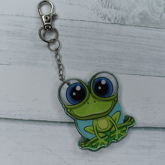 This Frog Keychain is hopping with happiness! Made from durable acrylic resin he comes with a green glitter background and a great happy smile.