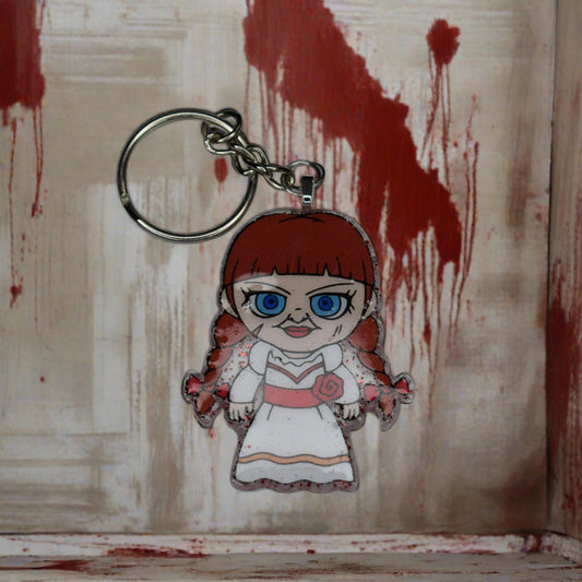 From our Horror Collection here is Annabelle. Hey, what is so scary about a doll....right? This Annabelle Keychain will show you exactly how scary a doll can be, Blood red glitter back and our big blue eyed Ananbelle doll on the front. Hand crafted from acrylic resin, strong and durable.