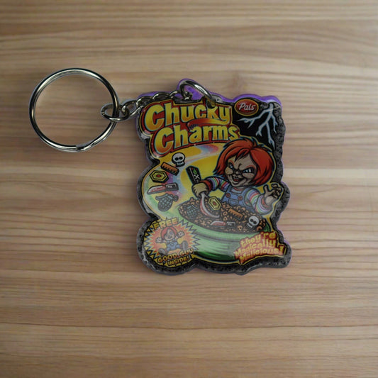 From our Horror Collection here is Chucky Charms. The&nbsp; perfect cereal for a Serial Killer. This Keychain features a dark grey glitter back and that crazy red headed doll in a bowl of his own cereal. Hand crafted from acrylic resin to be strong and long lasting.