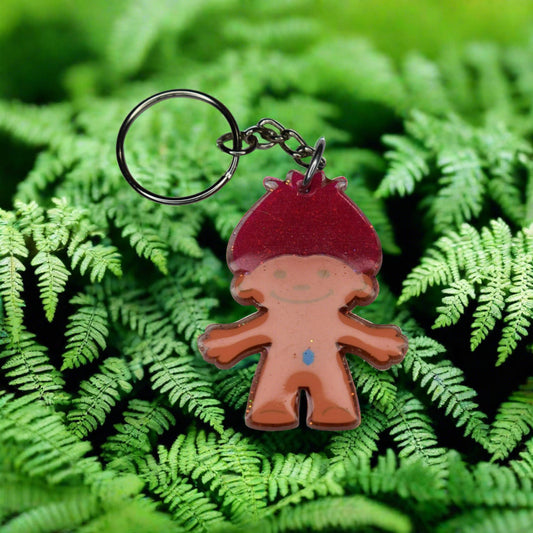 Take you back to the 80s and 90s on this one. Our Troll Doll with red hair and blue gem belly button Keychain will bring back fond memories.
