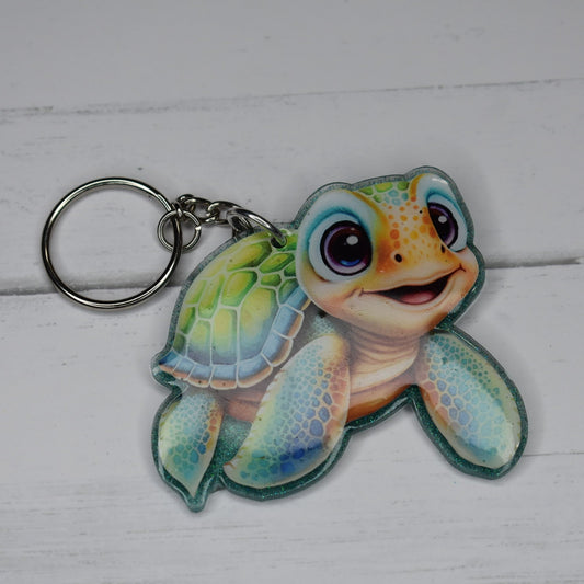 This snazzy keychain is a real catch - our Blue Sea Turtle, measuring 2.25" x 2.5" and made of sturdy acrylic resin. With his friendly grin, he's sure to be a crowd-pleaser.