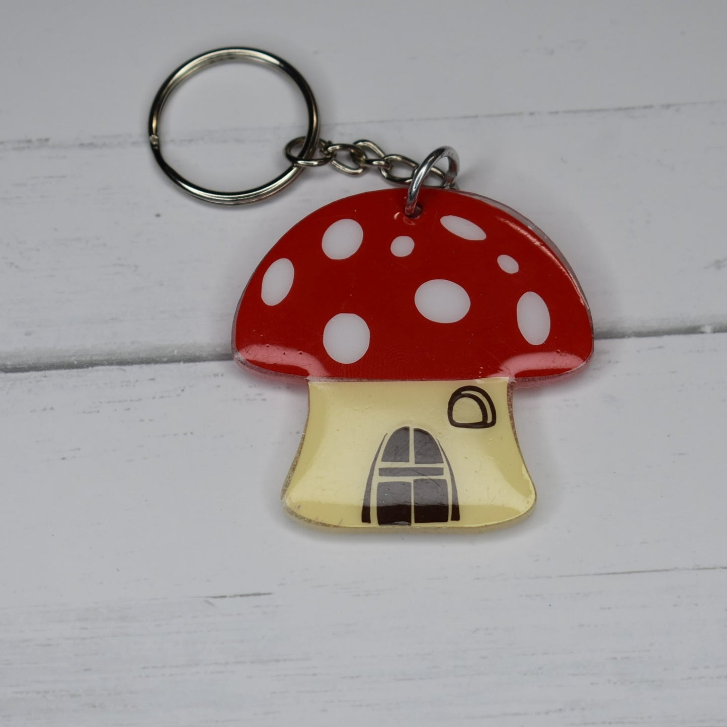 Made of durable acrylic, this creamy white base and iconic red-capped toadstool house will surely become a treasured possession for any gnome who calls it home.