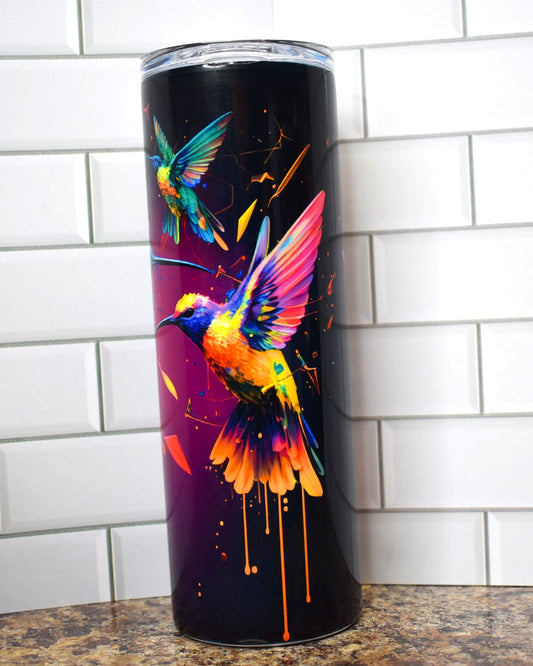 Hummingbirds dripping of paint are featured here on this Makerflo 20 oz tumbler. 