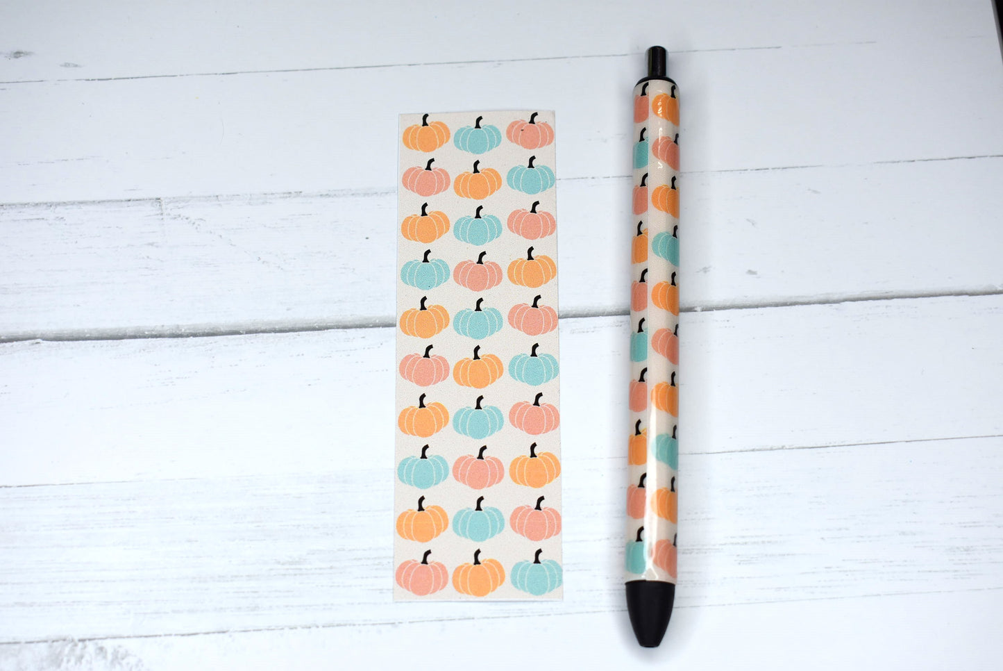 This Gel Pen has an Epoxy Resin finish, featuring various pumpkins in a orange teal & pink colors with black ink and one extra black ink refill.