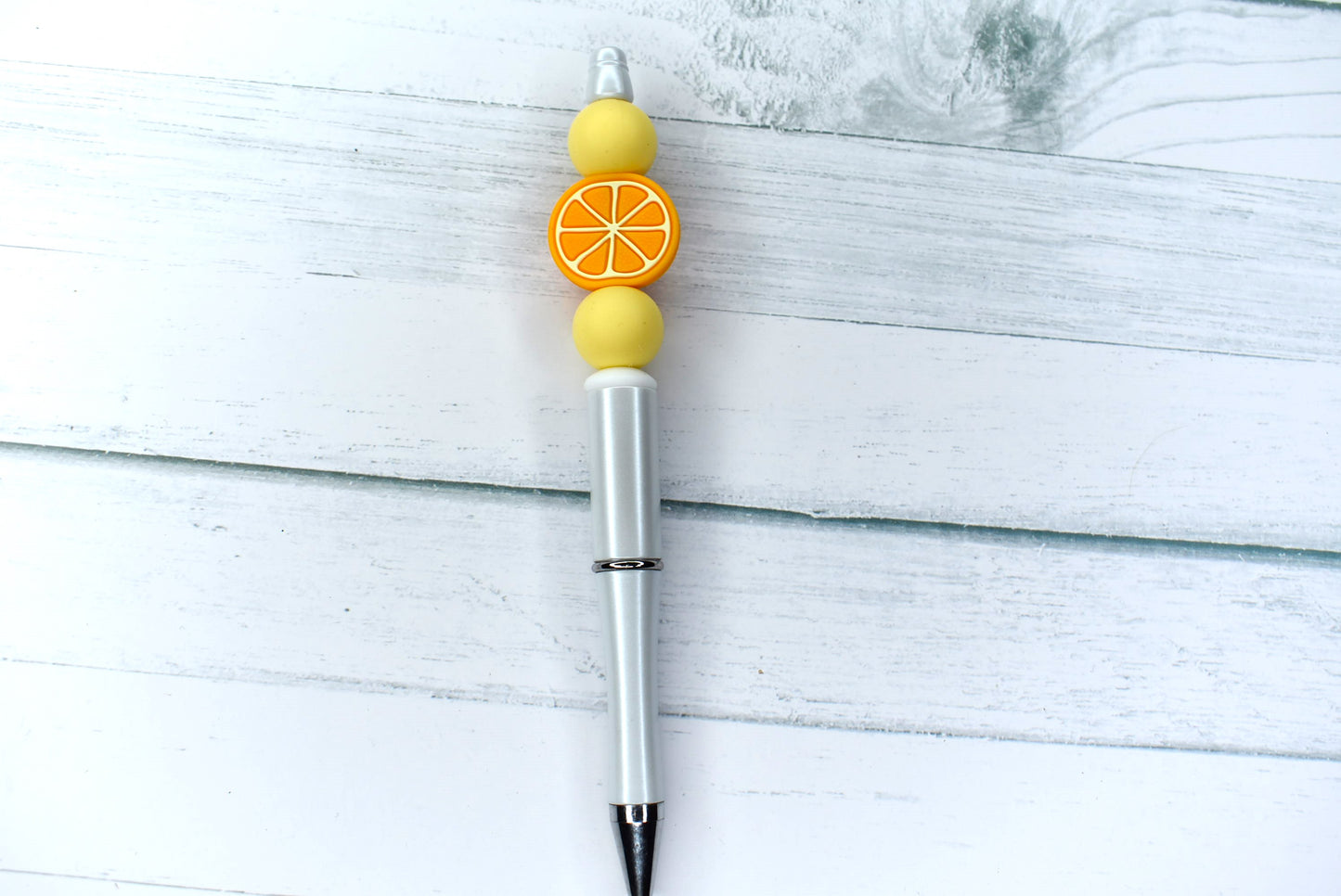 This Silicone beaded pen with Orange Slice bead and 2 yellow accent beads will get you daily Vitamin C fix. Comes with 1 extra refill.