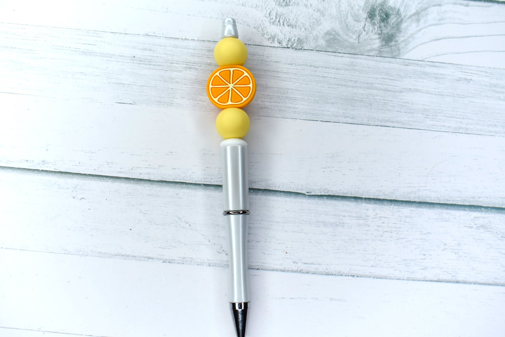 This Silicone beaded pen with Orange Slice bead and 2 yellow accent beads will get you daily Vitamin C fix. Comes with 1 extra refill.