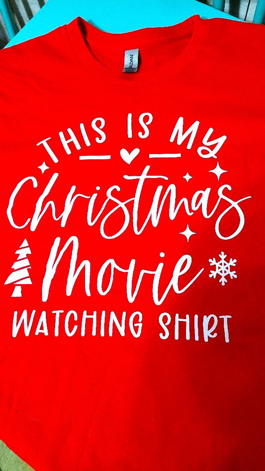 That time of year is here when you get your comfy clothes on, curl up on the couch with a drink and the remote and binge all your Christmas favorite movies. This T-Shirt is made with 5.3 oz. of 100% preshrunk cotton.