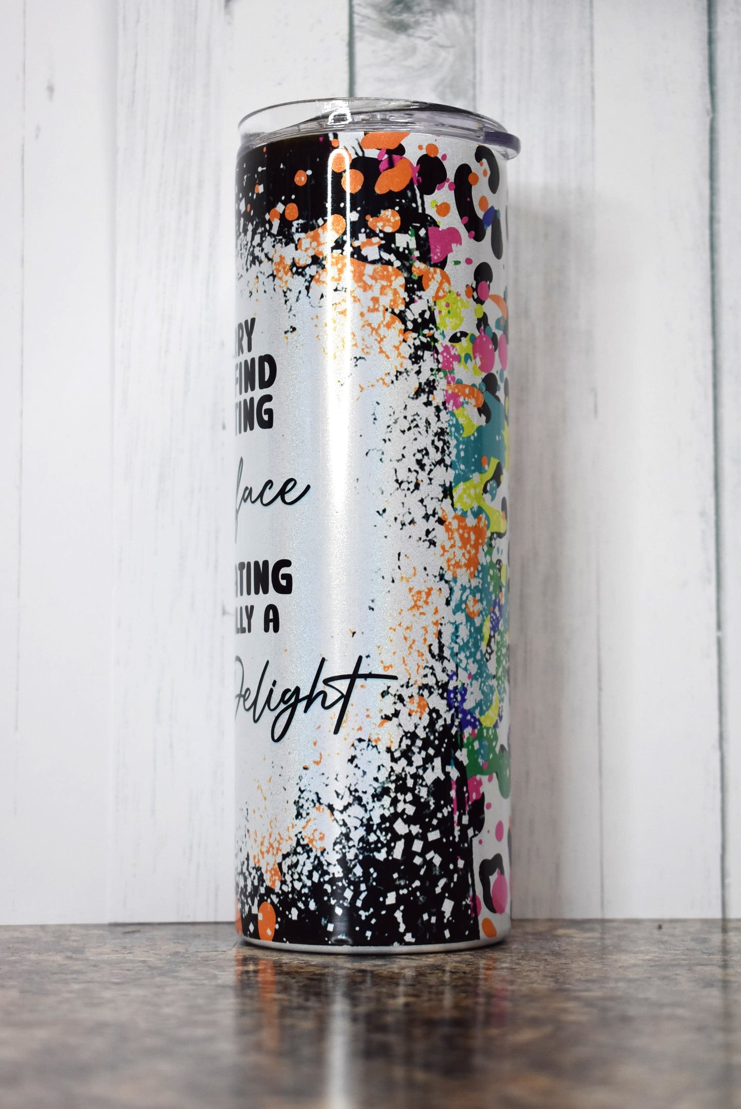 This 20 oz stainless steel Makerflo tumbler features colorful background image with a white splatter paint section with the phrase I'm Sorry If You Find My Resting Bitch Face Intimidating I'm Actually A Fucking Delight. 