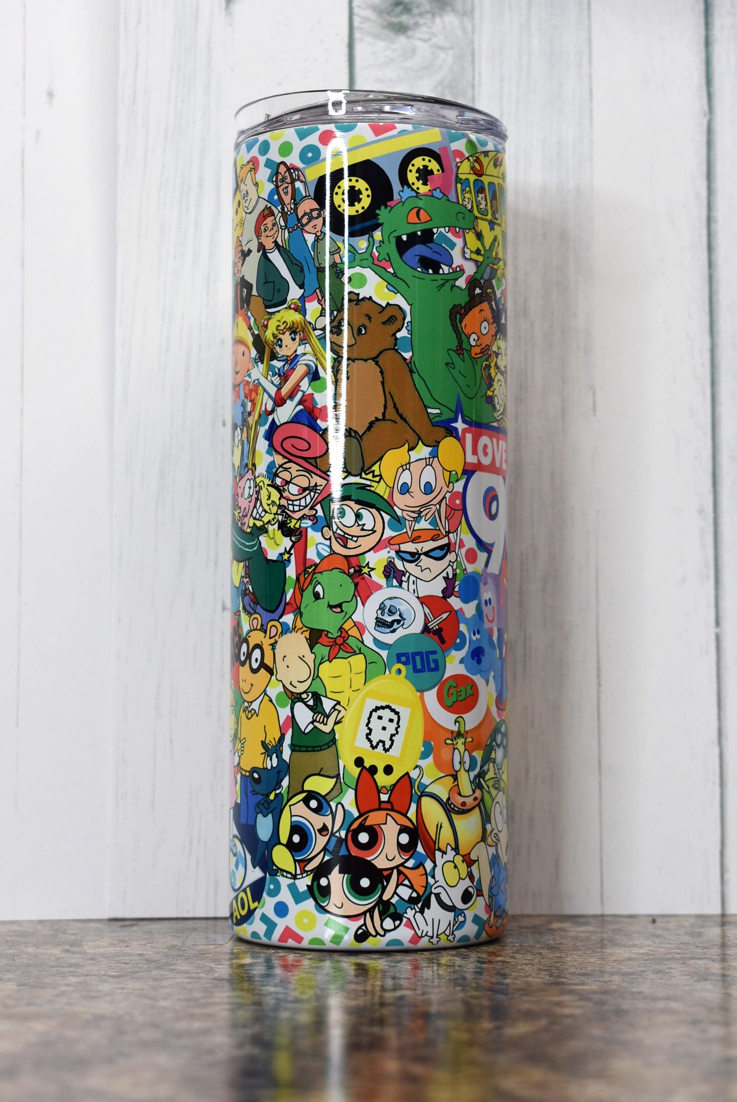 Turn back the clock to the 90s with this 20 oz tumbler. A stroll down memory lane as you pick out the many different iconic things from that decade. Sure to put a smile on your face.